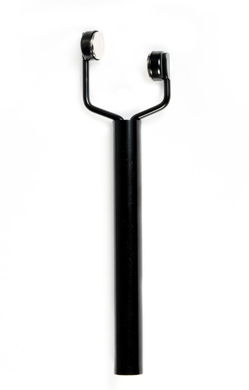Black metal tool with two magnetic ends on a white background
