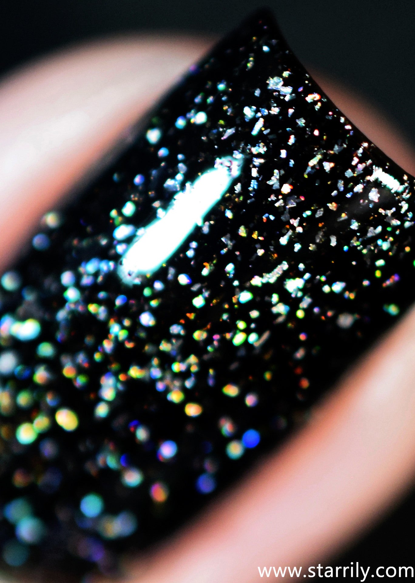 Starrily Adrenaline - Gorgeous jet black nail polish with dazzling silver holographic flakes. High quality nail polish. Made in the USA! Cruelty Free and Vegan.